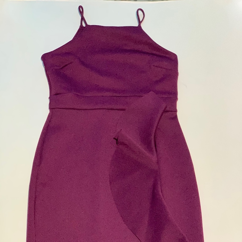 Purple dress has a small tiny leg slit
